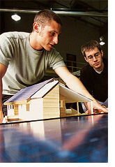 Students with model of the solar house