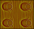 Click for high-res version: Template self-organization -- cylindrical pits on a silicon surface.